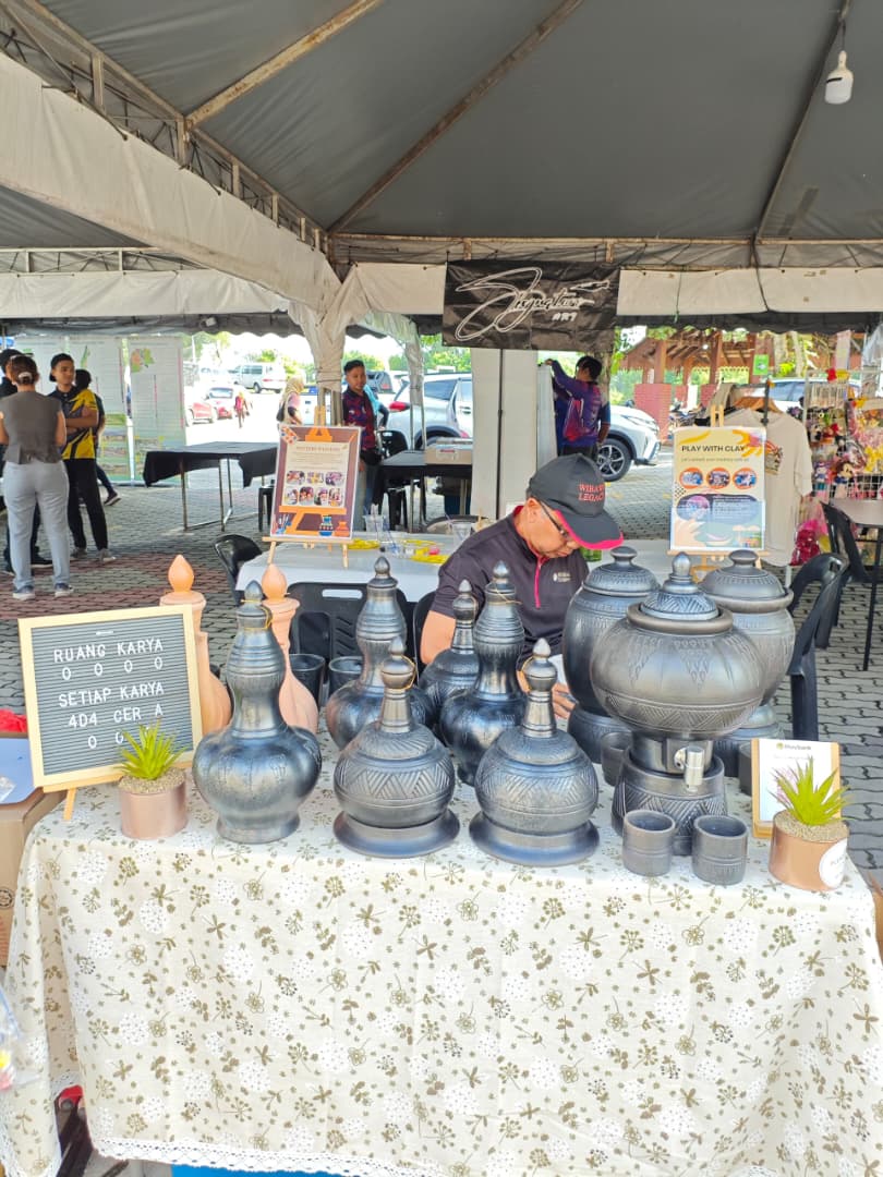 The Ruang Karya booth with ceramic pieces on display at a community carnival